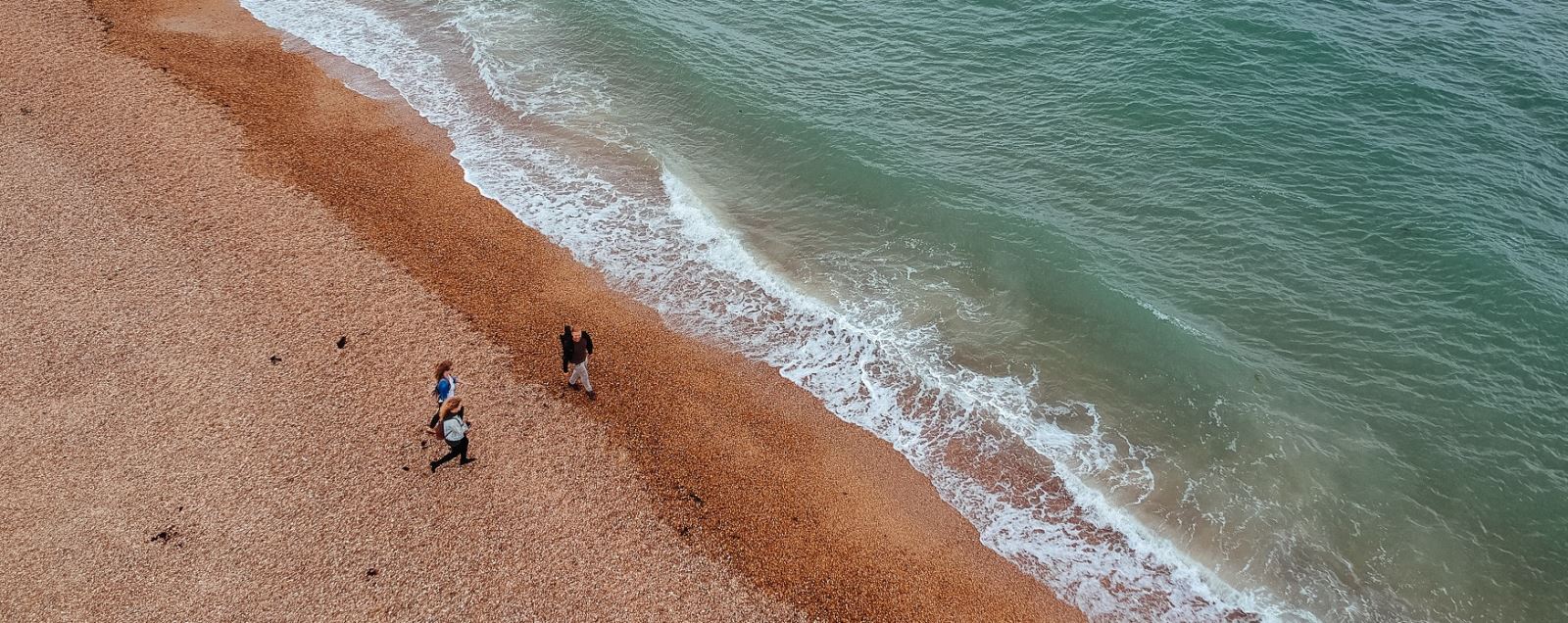 People walking along Southsea beach